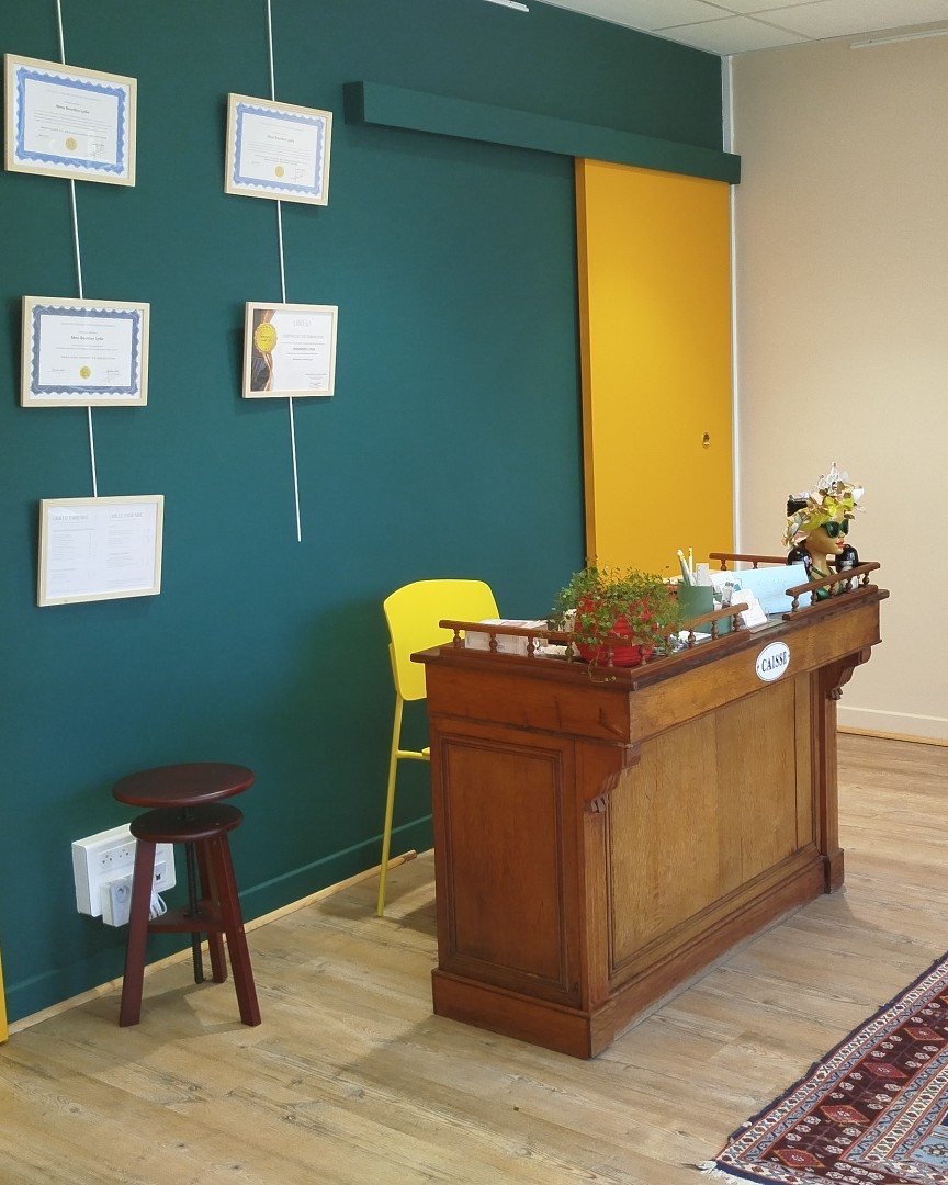 Le comptoir d’accueil du cabinet, avec ses plantes et sa lumière du jour